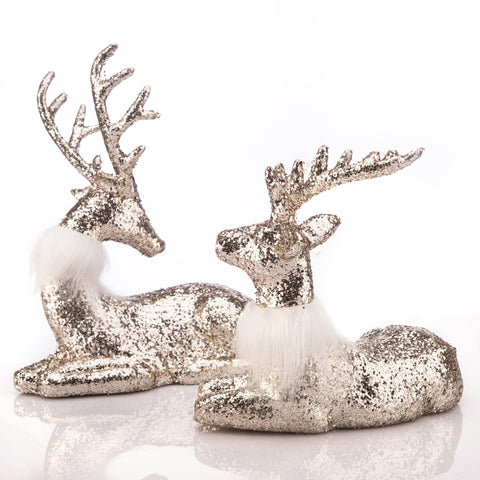 Two silver deer figurines.
