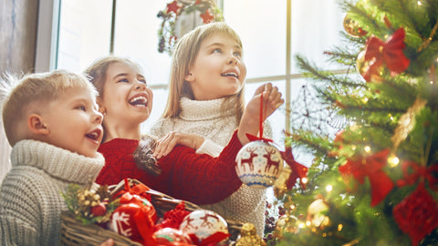 Kids decorating Christmas tree.