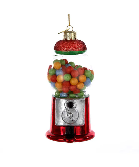 A Christmas ornament shaped like a gumball machine filled with colorful balls, complete with a glittery red top.