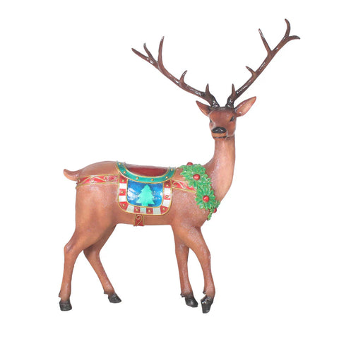 A brown decorative reindeer figurine with large antlers, adorned with a green wreath and a colorful saddle.