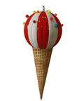 A whimsical 26" Ice Cream Jumbo Finial by ACRO resembling an ice cream cone, featuring a red and white striped spherical scoop topped with colorful pom-poms, sits atop a golden textured cone. Perfect for seasonal decor, it brings a playful touch to your spring and summer displays. The image is on a white background.