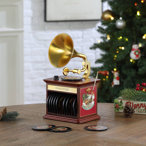 Vintage phonograph on a table with Christmas decor.