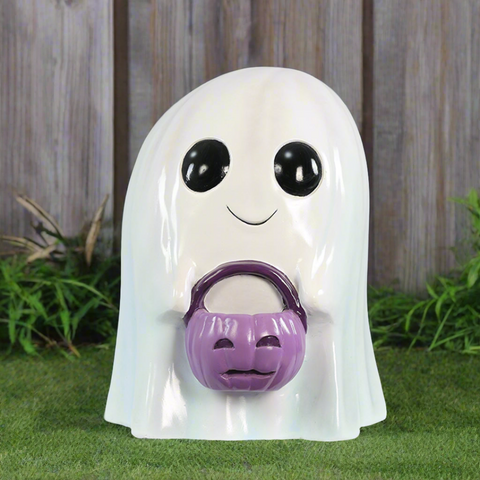 Smiling ghost decoration holding a purple pumpkin basket.